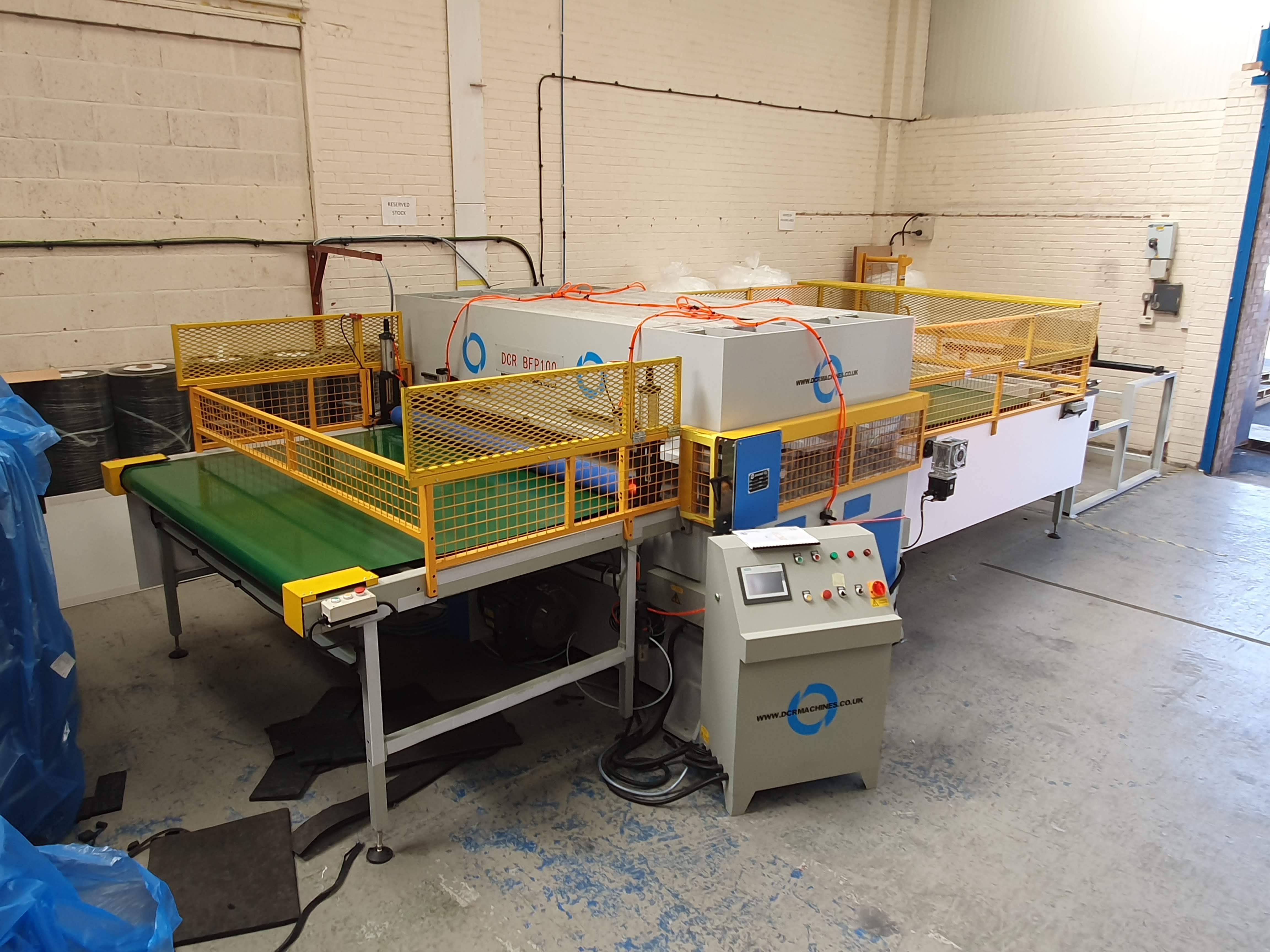 Photo of an DCR-BFP100 BELT FEED FULL BEAM PRESS 100T Industrial Sewing Machines